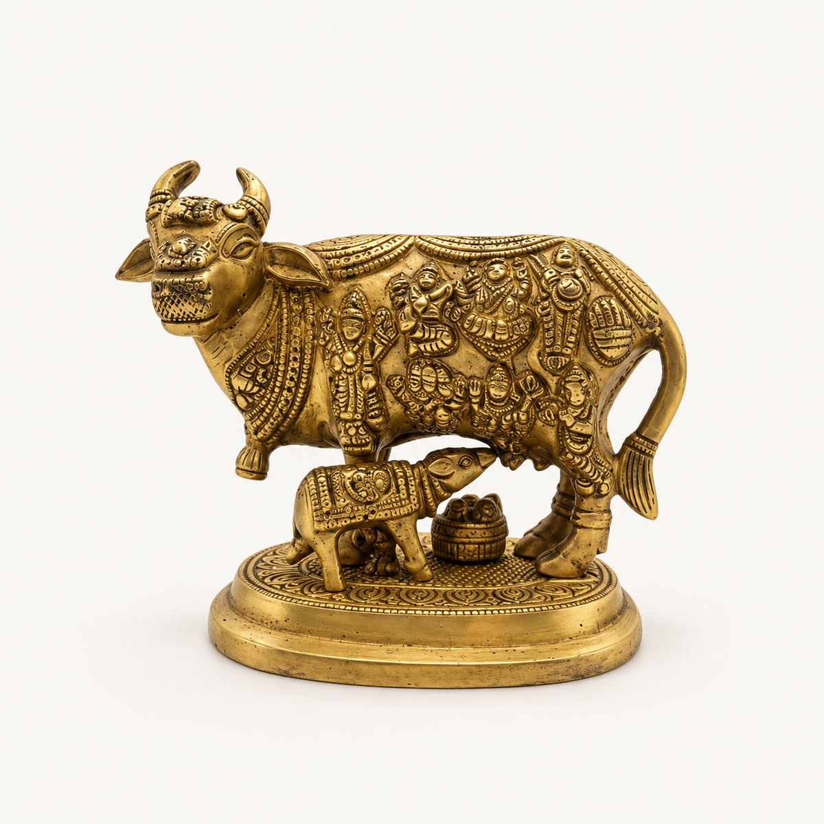 Kaam Denu Cow With Calf Brass Statue on a warm white studio background