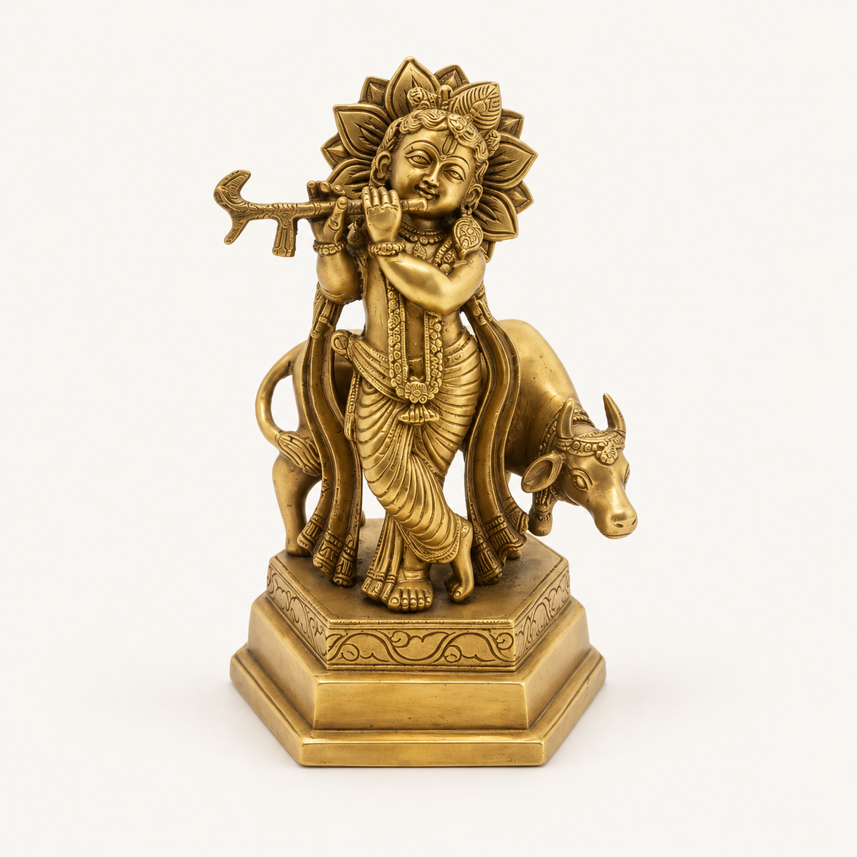Krishna With Cow Brass Statue on a warm white studio background